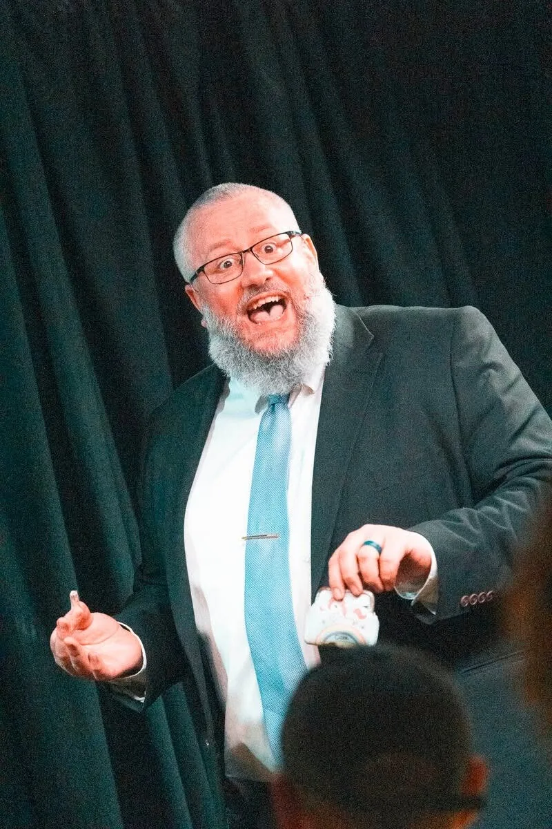 Rich Newman performing and interacting with an audience