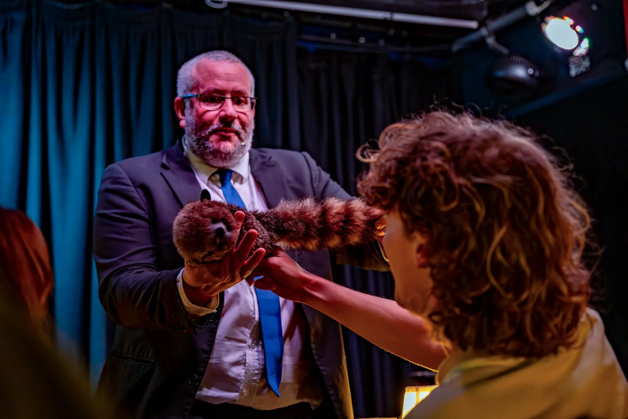 Rich Newman interacting with an audience member on stage