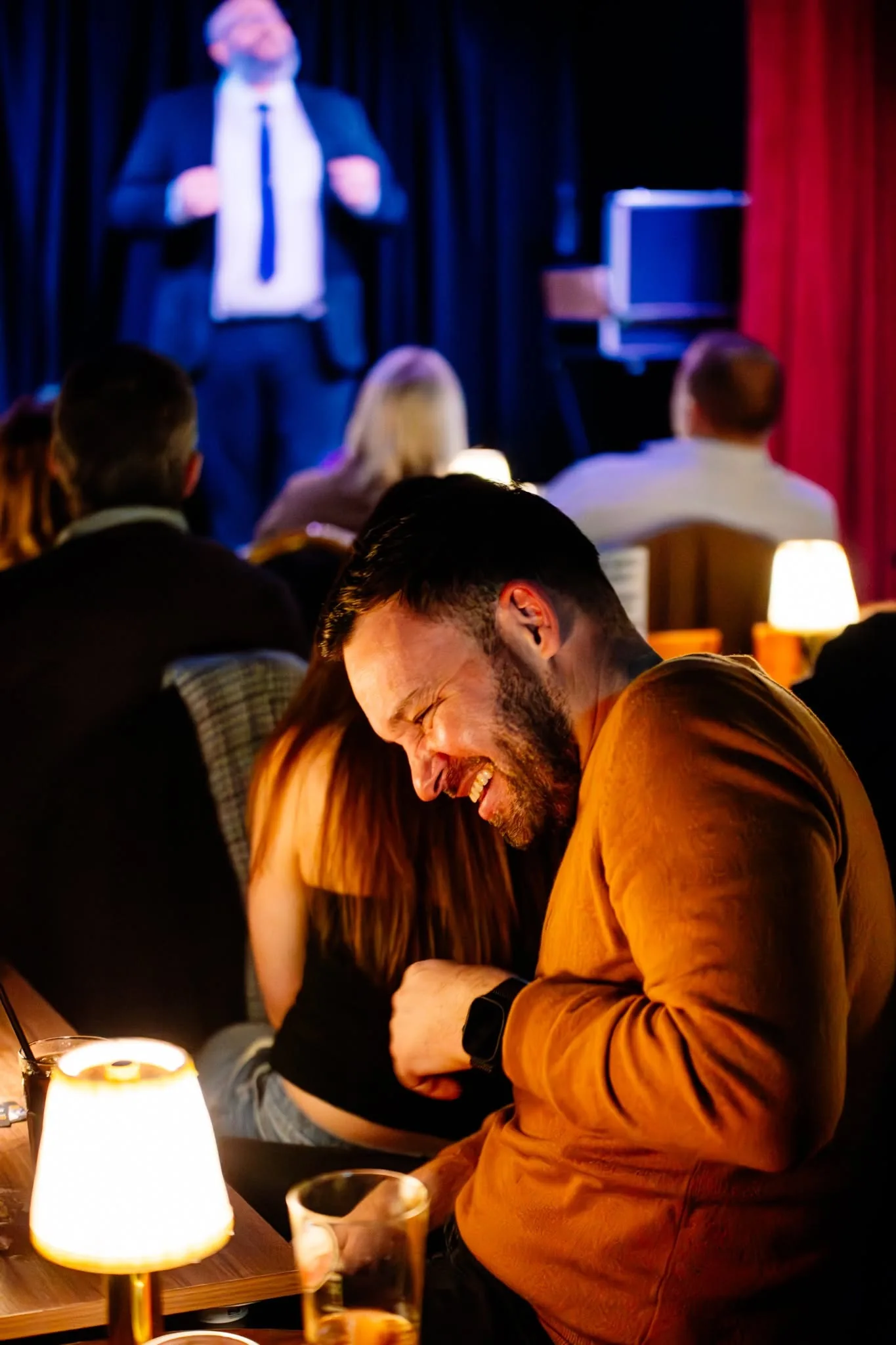 A spectator laughing during a Rich Newman comedy magic performance